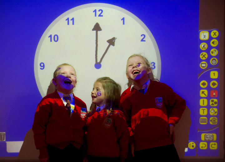 Caoilinn Cahill, Scarlett Williams and Riona Williams having fun with a clock on the interactive white board at Inch N.S. Photograph by John Kelly.